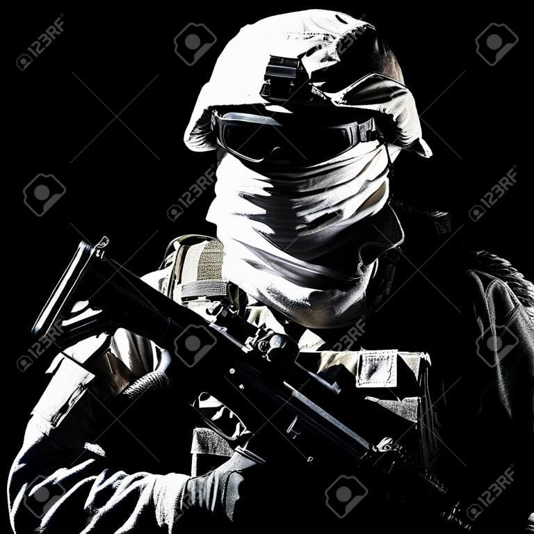 Shoulder portrait of war, military conflict combatant, army special forces soldier, counter terrorist forces fighter armed with rifle in combat helmet, glasses and mask cropped on black background