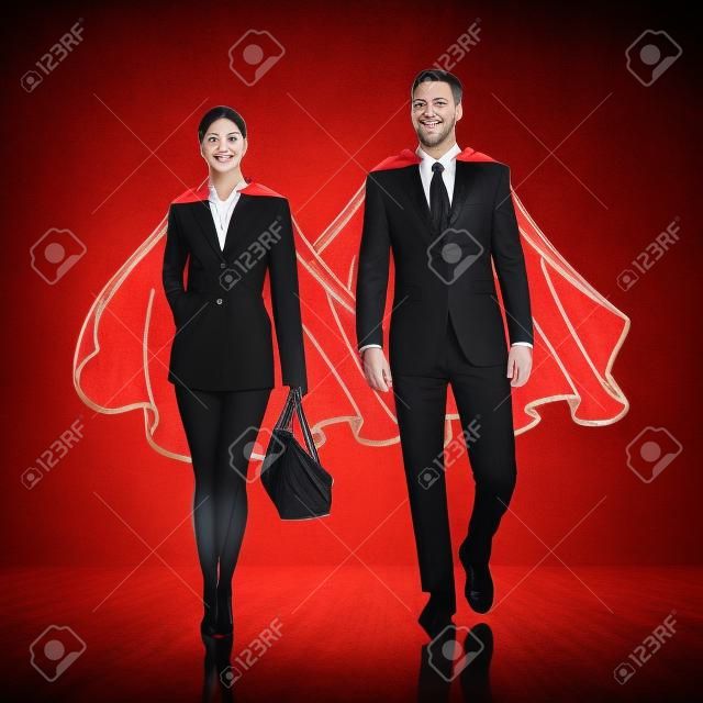 Business heroes couple with red cloak