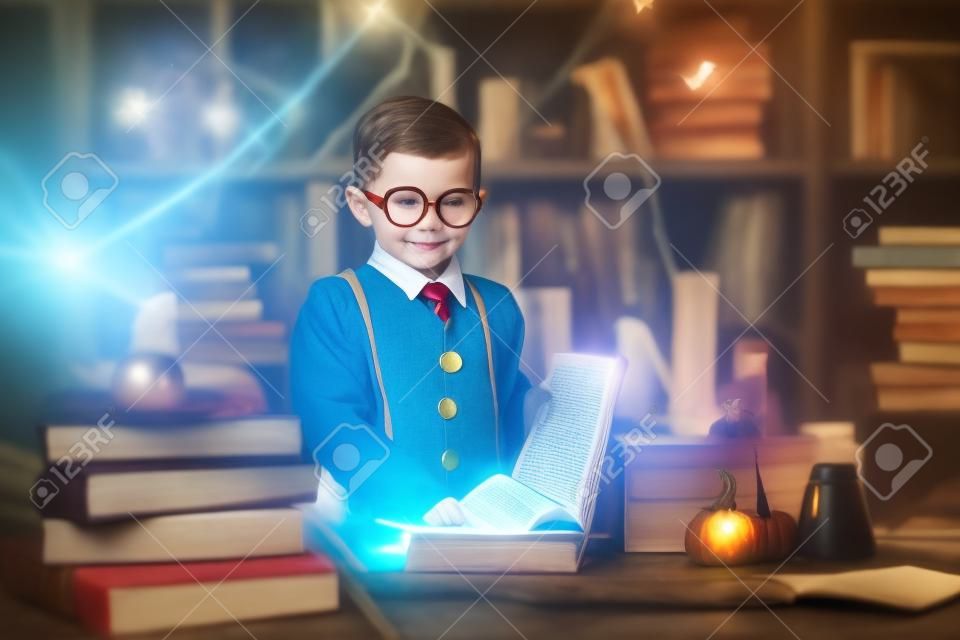 Small happy wizard reads magic book Cosplay. Halloween costume party. Decorate studio background