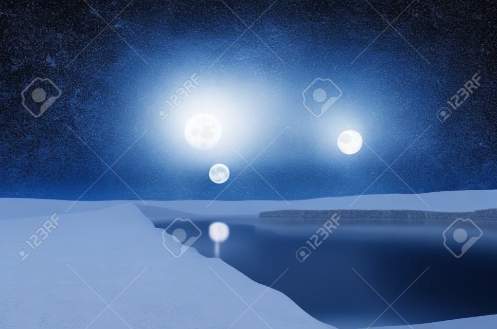 Landscape of gorgeous full moon over the snow-capped mountains reflected in the river or mysterious night sky with full moon