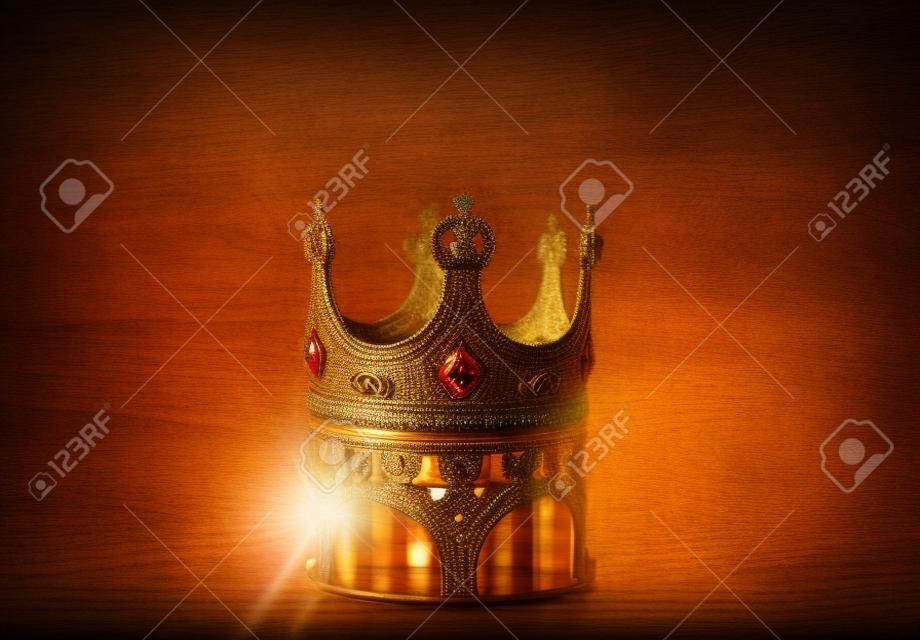 image discrète de la belle couronne de reine / roi sur une table en bois. millésime filtré. période médiévale fantastique. Mise au point sélective. Rétroéclairage coloré