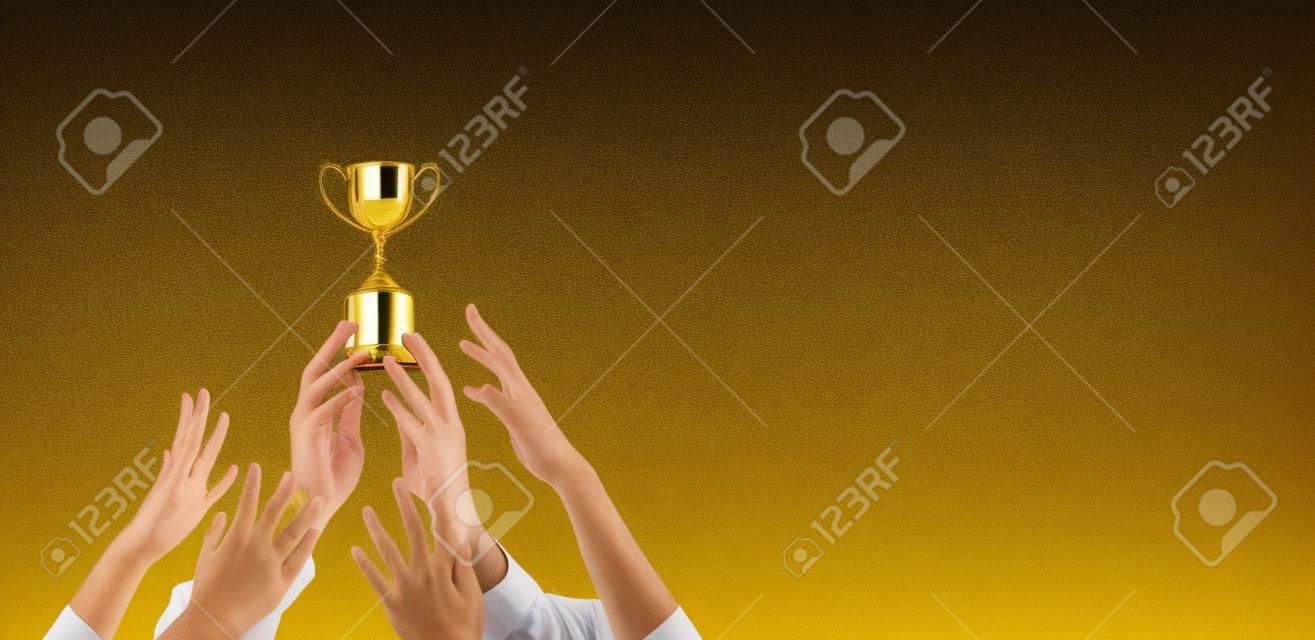 Hands scramble for the golden trophy cup, concept business