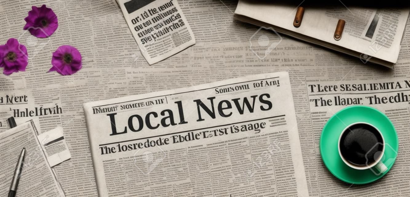 Un journal sur un bureau avec le titre Nouvelles locales