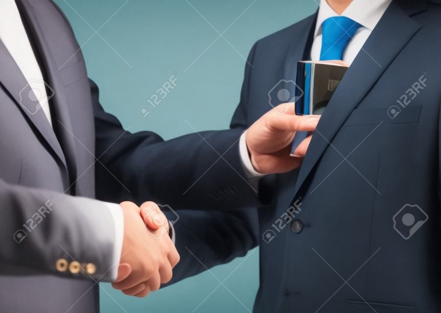 Giving a bribe into a pocket - closeup shot