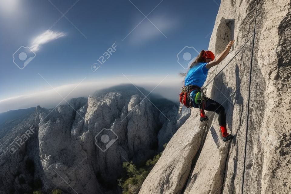Rock climbing and mountaineering in the Paklenica National Park. A woman overcomes a challenging climbing route on natural terrain. Climber trains on the rocks of Croatia.