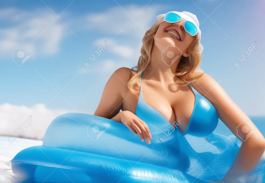 Woman relaxing on inflatable mattress. 