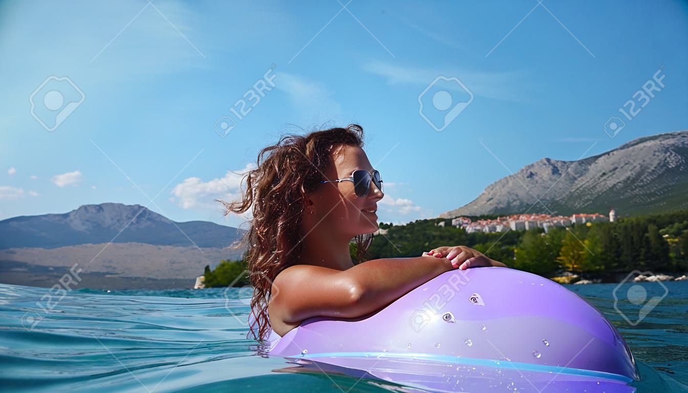 Gorgeous scenic view of young girl sunbathing on Adriatic waters in Croatia 