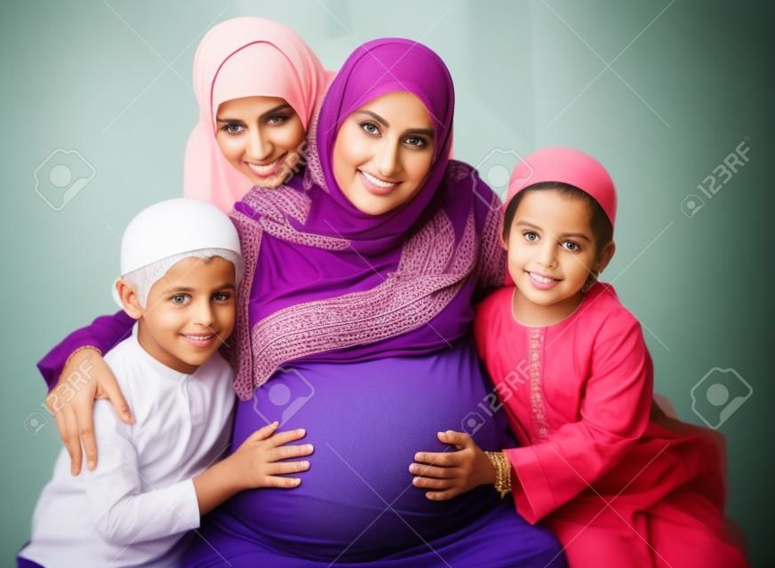 Muslim pregnant woman with her children around