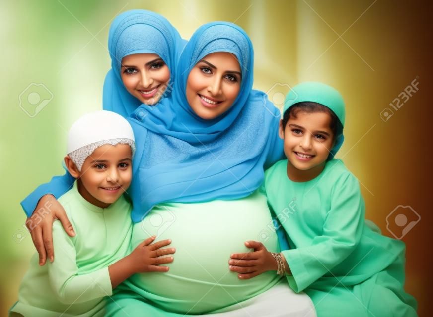 Muslim pregnant woman with her children around