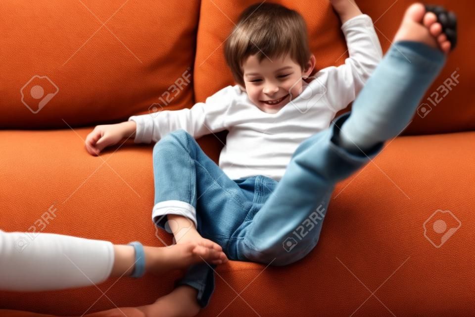 Niño Joven En El Sofá Con Las Orejeras Imagen de archivo - Imagen de mano,  fastidio: 27921349